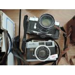 Two Minolta cameras, a Hi-matic and a SR-1