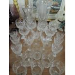 A selection of cut glass wine and spirit glasses and three vases