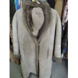 A ladies long sheepskin coat having shawl collar and matching hat