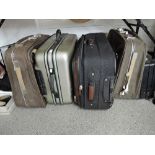Four assorted suitcases and a briefcase