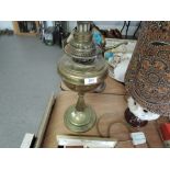 A vintage brass bodied oil burning lamp