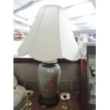 A vintage hand decorated table top lamp