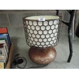 A modern style table lamp with rustic style shade