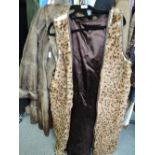 A ladies faux fur long waistcoat and vintage fur coat
