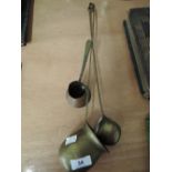 A selection of copper and brass measuring pot / ladles brandy and whisky