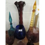 A selection of coloured glass bowls, vases and bottles