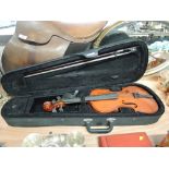 A vintage violin with case and bow