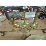 A late Victorian/Edwardian brass ceiling light of rise and fall design, and two brass table lamps