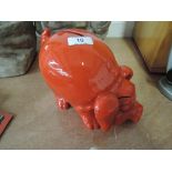 A oriental style ceramic piggy bank with red glaze