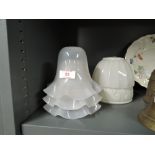 Three glass light shades and a ceramic lamp shade