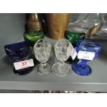 A selection of vintage doctors eye baths or washes various glass colours and designs