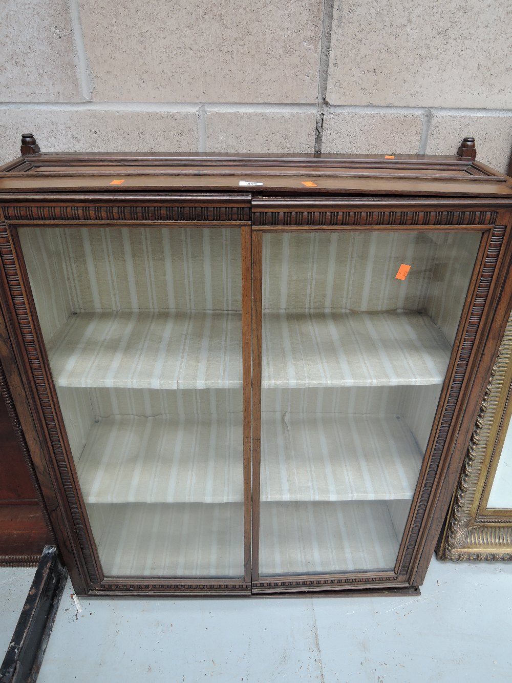 A vintage display or book case with glass front doors