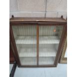 A vintage display or book case with glass front doors