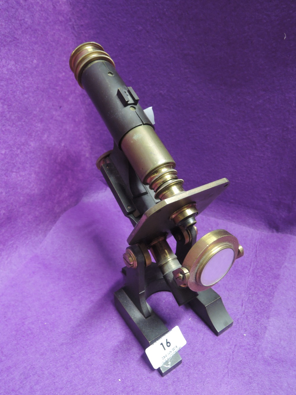 A vintage scientific microscope with brass fitments