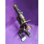 A vintage scientific microscope with brass fitments