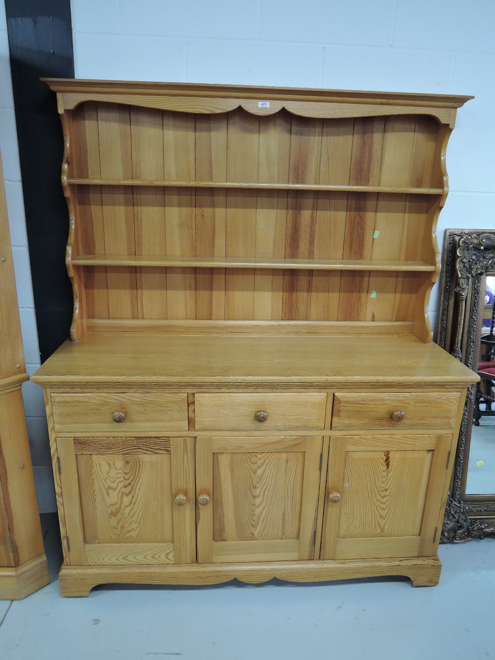 A modern pine dresser three drawers and under cupboards