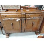 A vintage oak side board with carved details