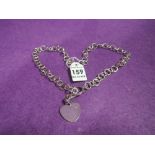 A silver bar and link necklace having a plain heart shaped charm