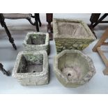 Four ornamental concrete garden planters