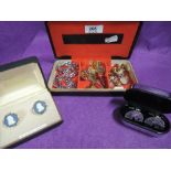 A travel jewellery case containing a selection of cufflinks etc