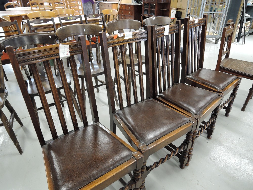 A set of four vintage dining chairs with twist work front