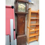 An antique grandfather clock with brass face named John Hartley