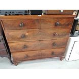 A set of antique two over three drawer set with flame mahogany style veneer fronts