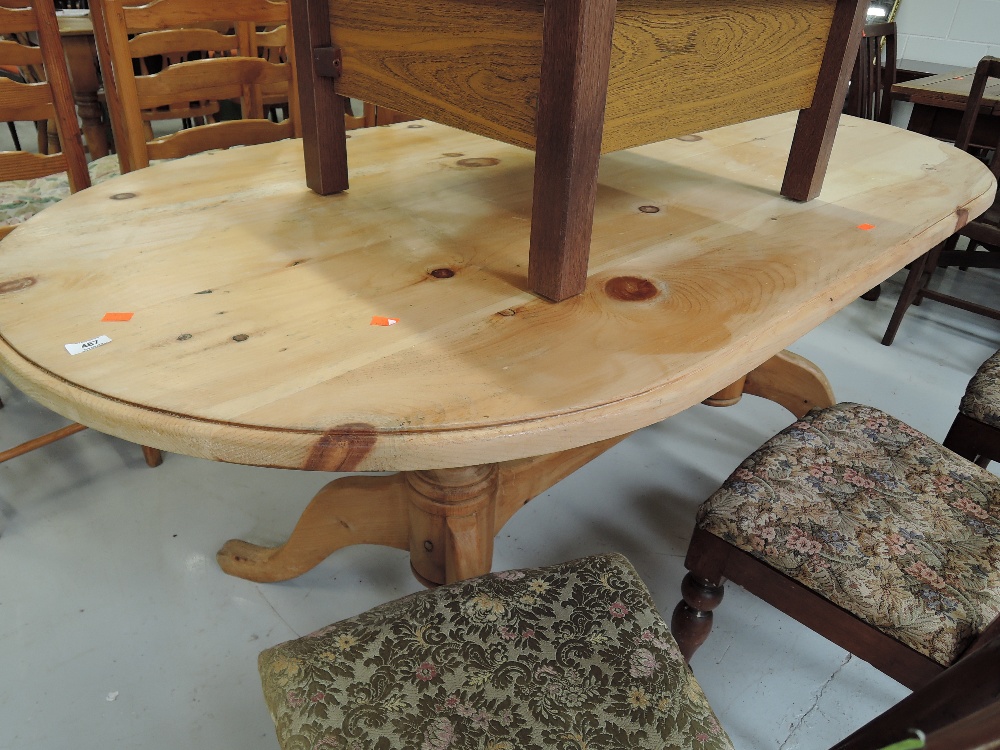 A vintage pine dining table with double pedestal base