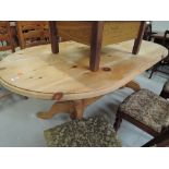 A vintage pine dining table with double pedestal base
