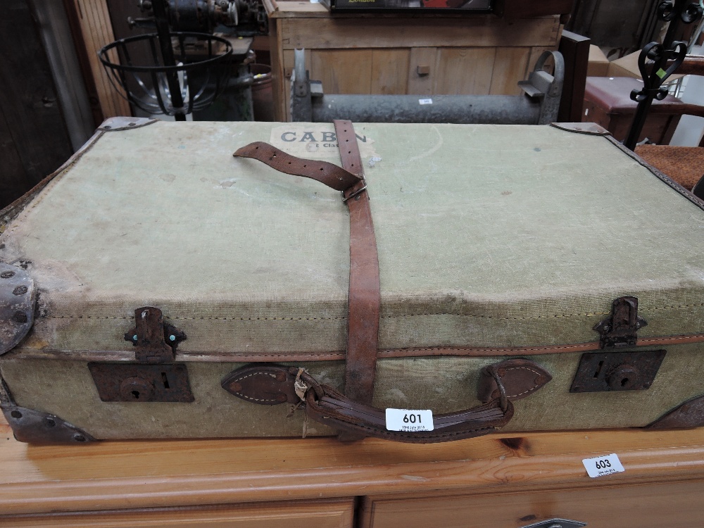 A vintage suitcase with cabin badge