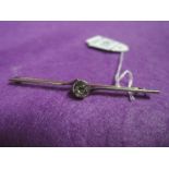 A white and yellow metal bar brooch stamped sterling silver having a central stone, possibly a white