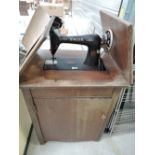 A vintage Singer sewing machine with treddle mechanism