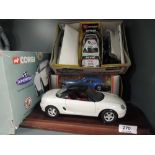 A Corgi 1:18 scale diecast, MGF on display plinth and two Burago diecast cars, all boxed