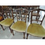 A set of three salon chairs with carved backs