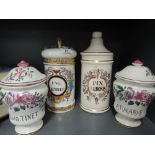 Four decorative lidded containers or apothecary jars
