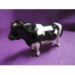 A vintage cow figure by Beswick