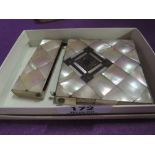 A mother of pearl card holder having white metal decoration on a chequered background, AF