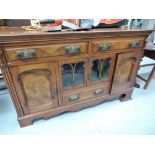 A Victorian sideboard with two drawer, glass door central cupboard and under drawer