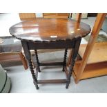 A twist leg occasional table with scalloped top