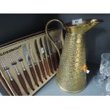 An arts and crafts style jug and Glosswood cutlery set