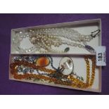 A selection of costume jewellery including amber coloured glass beads, crystal beads, diamante etc