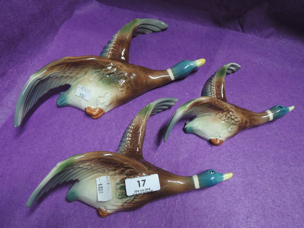 A set of graduated ceramic ducks wall mounted plaque style