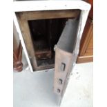 A vintage heavy brass and cast fire resistant safe with key