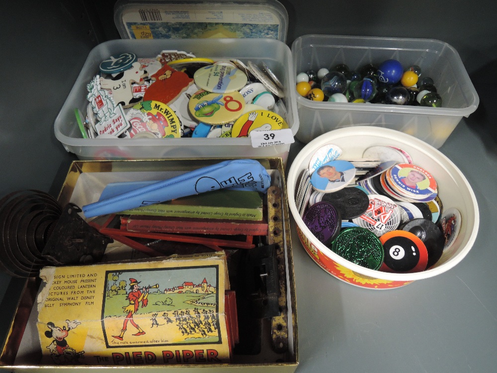 A selection of vintage marbles, badges, children's lantern slides etc