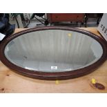 A vintage oval hallway mirror