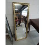 A modern gilt frame wall mirror