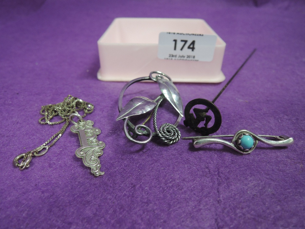 Four pieces of HM silver and white metal stamped silver including hat pin, brooches, pendant etc