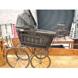 A vintage childs size wicker pram