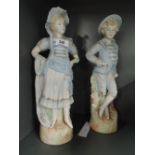 A pair of vintage tall standing bisque figures with French themes