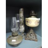 A selection of vintage oil burning lamps and spare chimneys